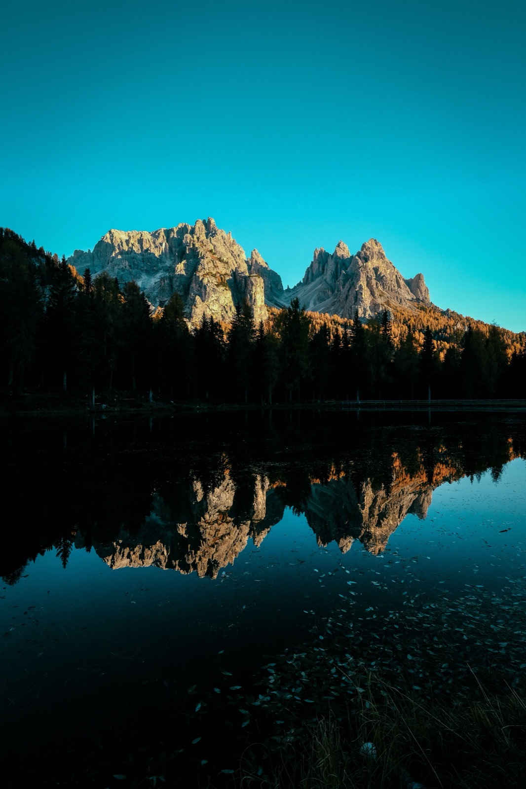 Snow-capped peaks mirrored in a still turquoise lake